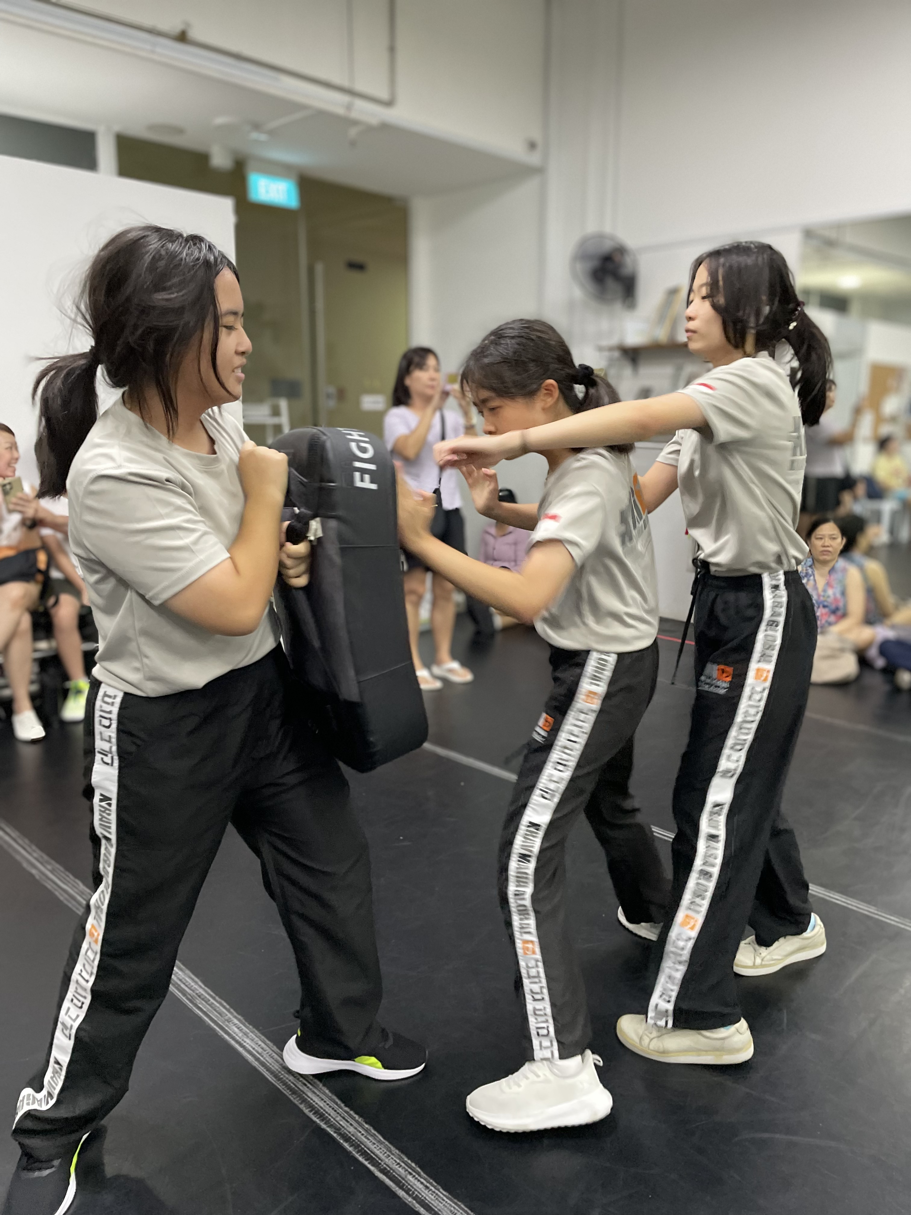 Teens working a pad drill